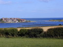 a view of Alnmouth from the other side of the river aln showing the estuary and the sea